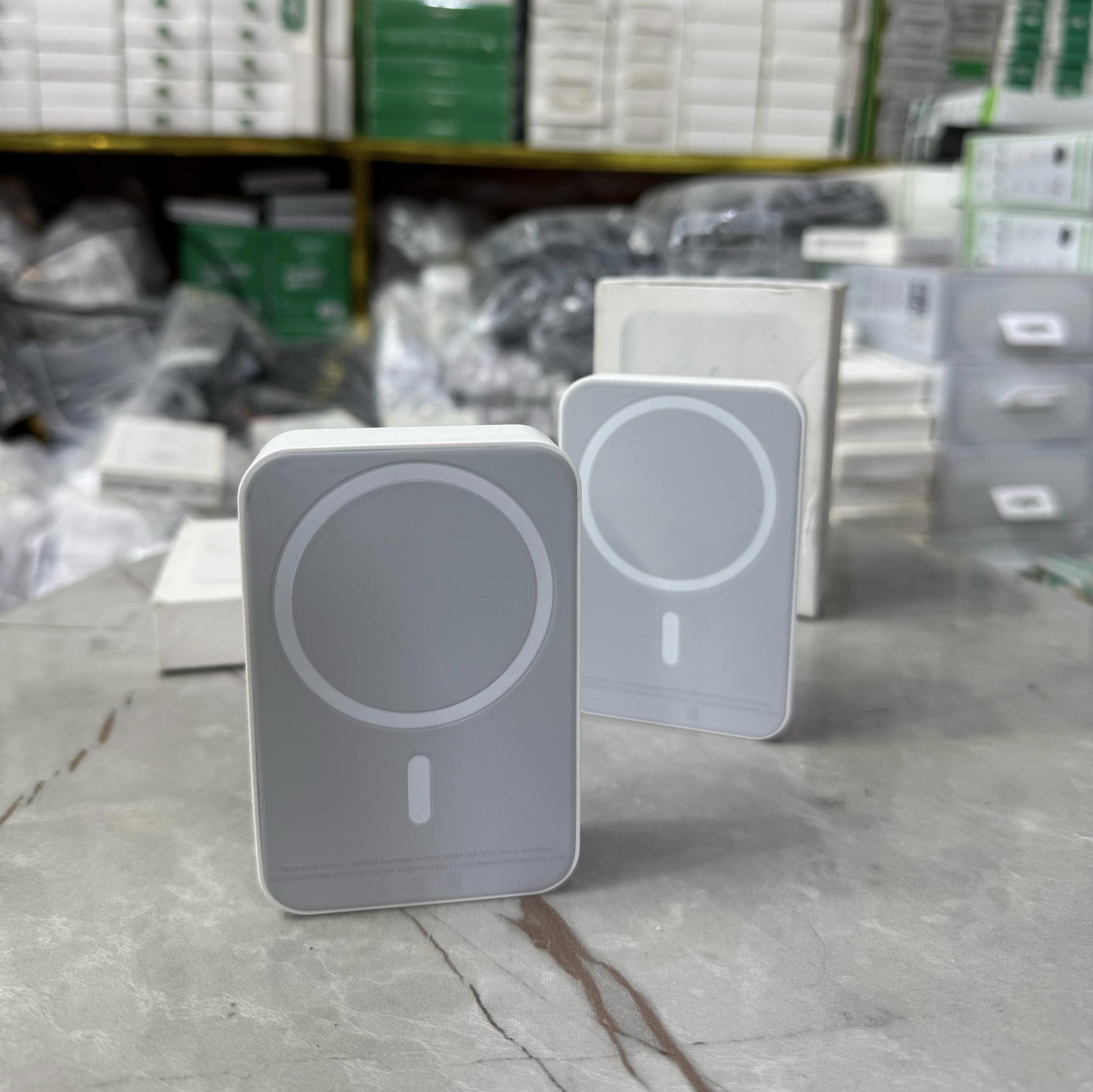 Slim and modern MagSafe-compatible wireless power banks in white, designed for fast and efficient charging. Featuring a sleek rectangular design with a circular magnetic alignment, these portable chargers provide seamless attachment for iPhone users seeki