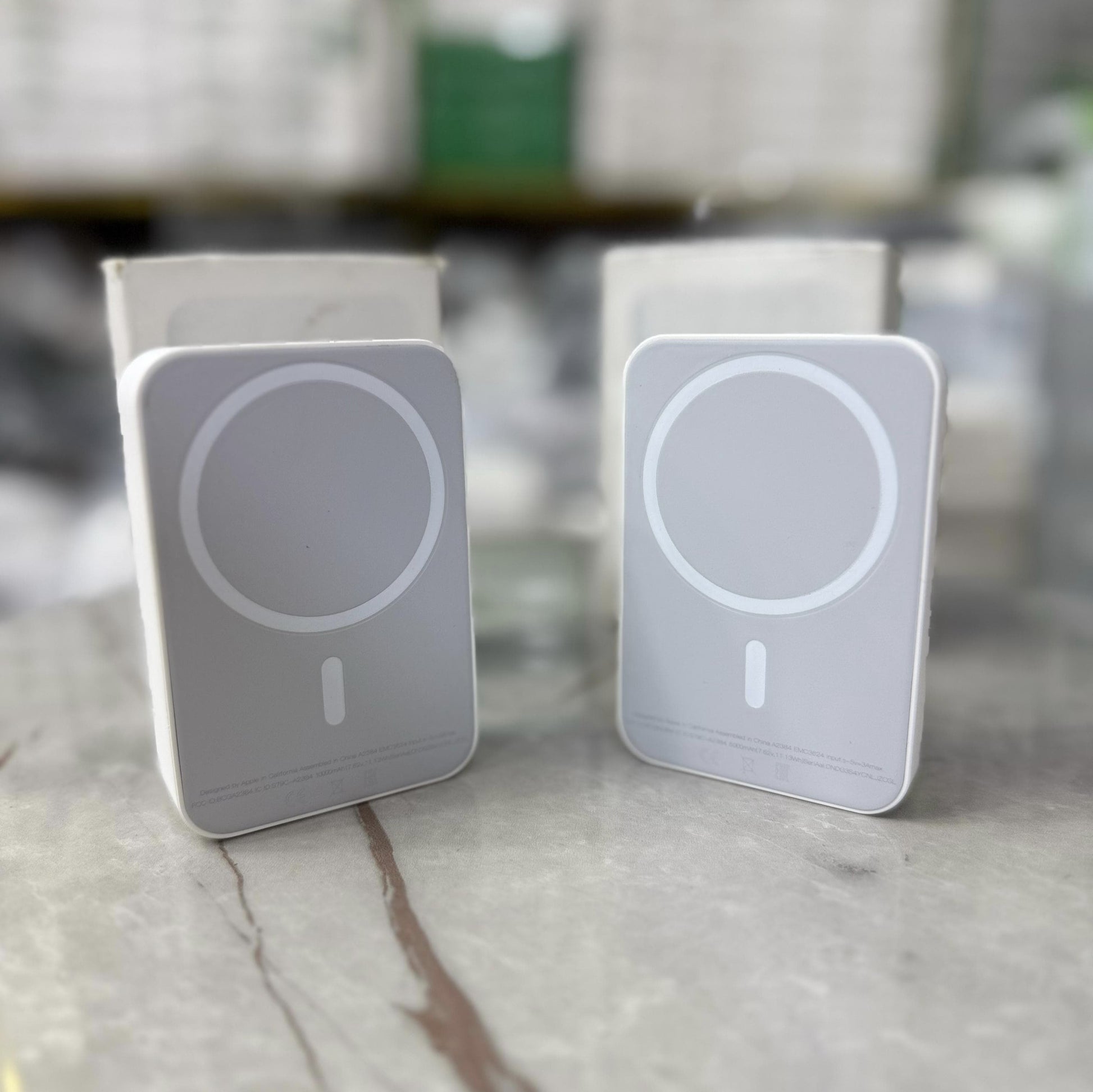 Slim and modern MagSafe-compatible wireless power banks in white, designed for fast and efficient charging. Featuring a sleek rectangular design with a circular magnetic alignment, these portable chargers provide seamless attachment for iPhone users seeki