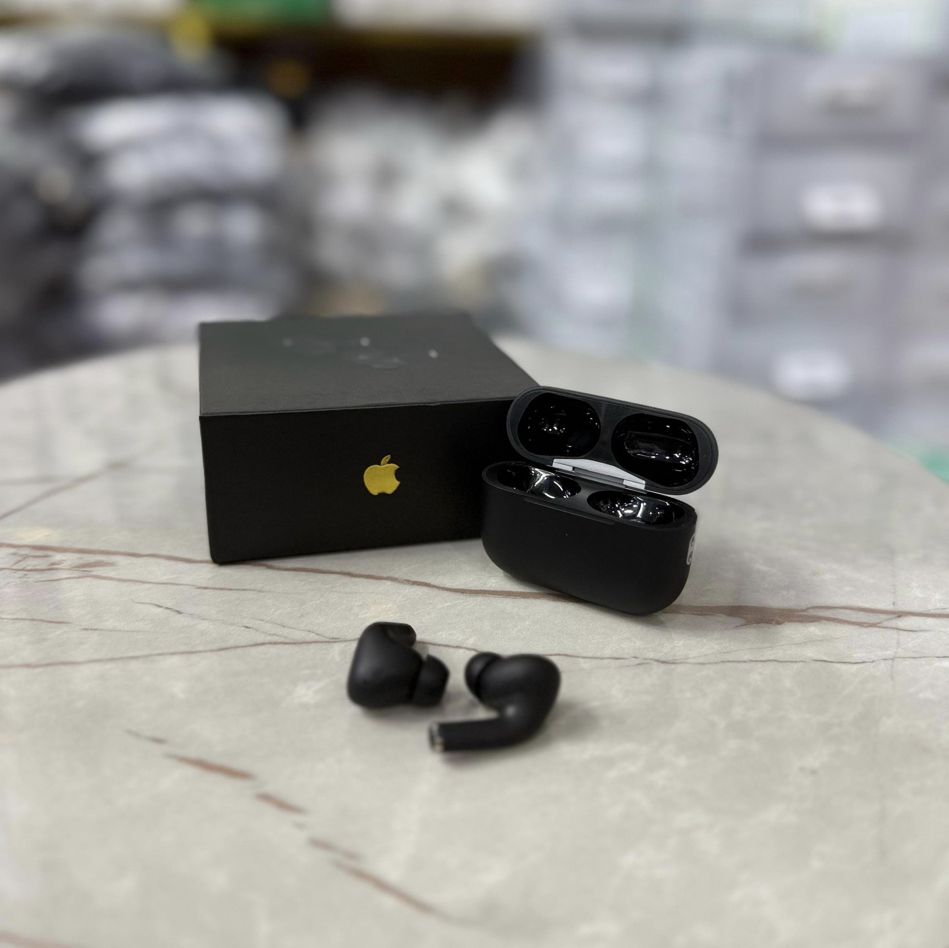 Matte black AirPods Pro-style wireless earbuds with active noise cancellation, displayed in an open charging case alongside a sleek black packaging box. The earbuds have a premium finish, making them a stylish choice for high-quality Bluetooth audio. Perf
