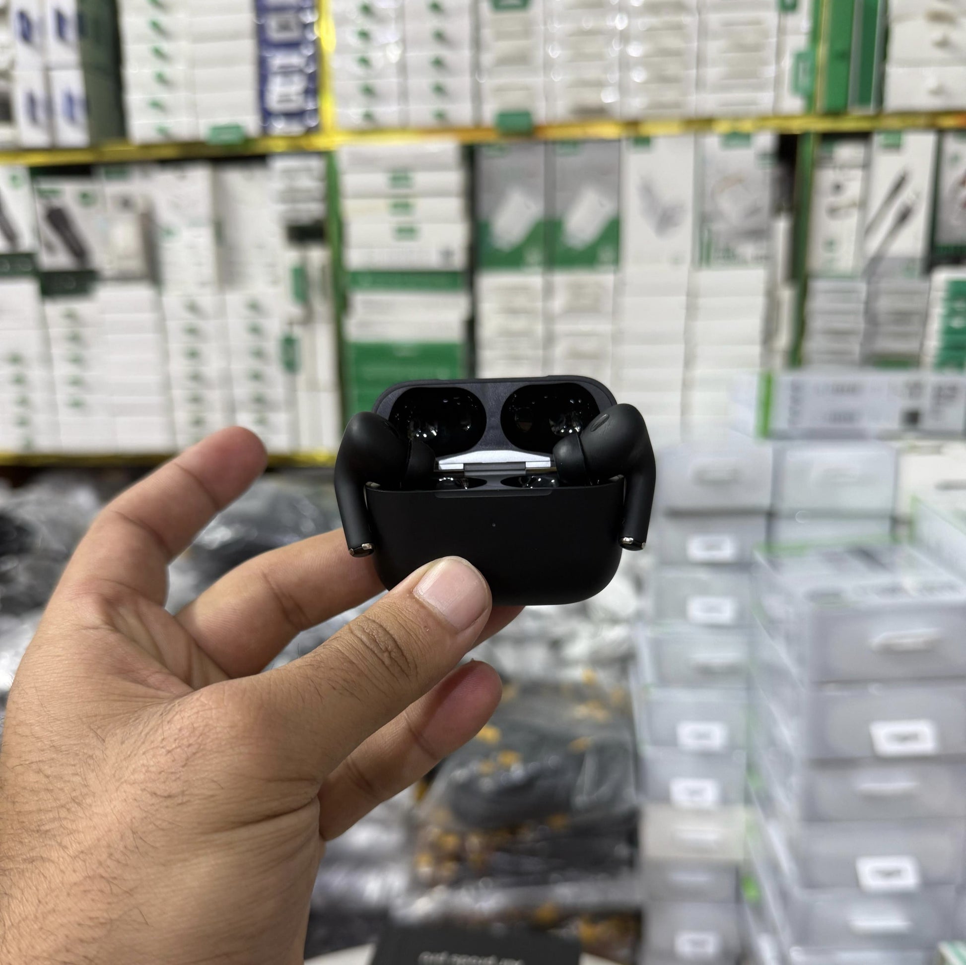 Matte black AirPods Pro-style wireless earbuds with active noise cancellation, displayed in an open charging case alongside a sleek black packaging box. The earbuds have a premium finish, making them a stylish choice for high-quality Bluetooth audio. Perf